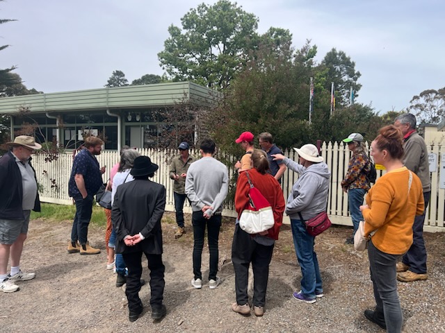 Group gathering outside in front of a building.