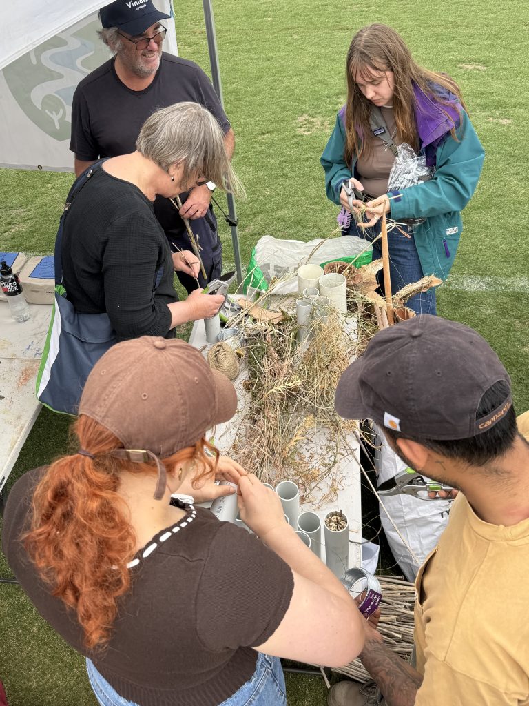 People crafting eco-friendly items at outdoor workshop.