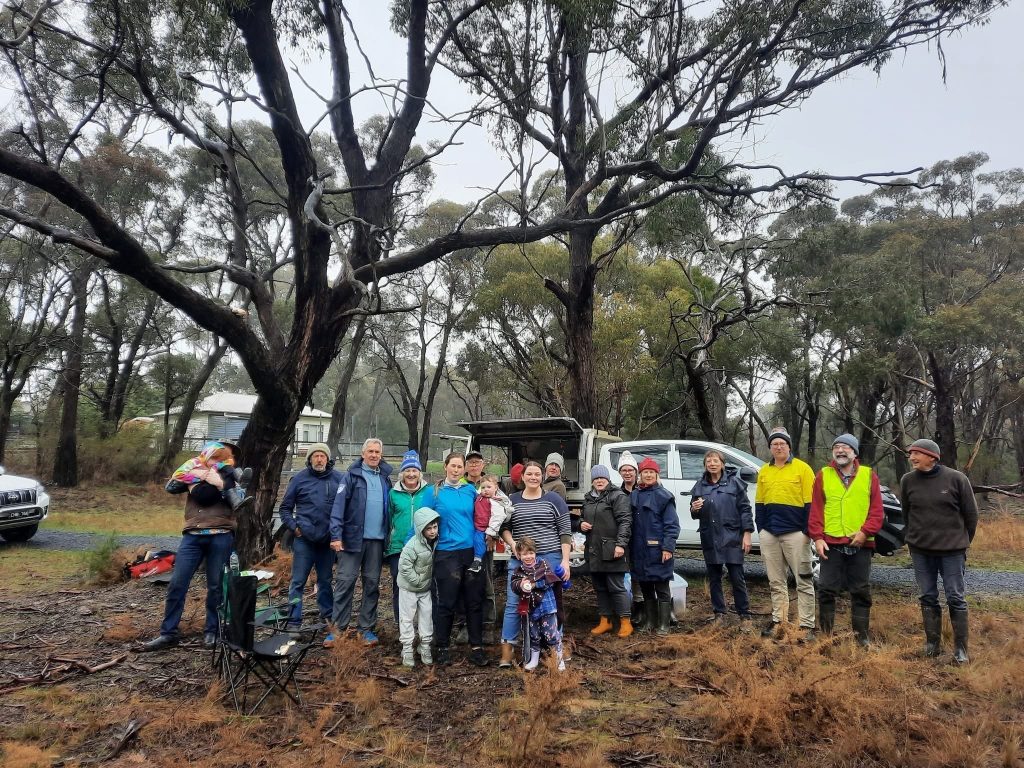 Group of people enjoying a rainy bush gathering.